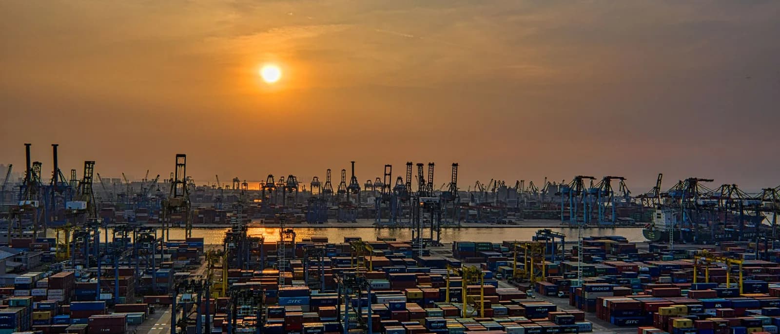 Container terminal at a port at sunset