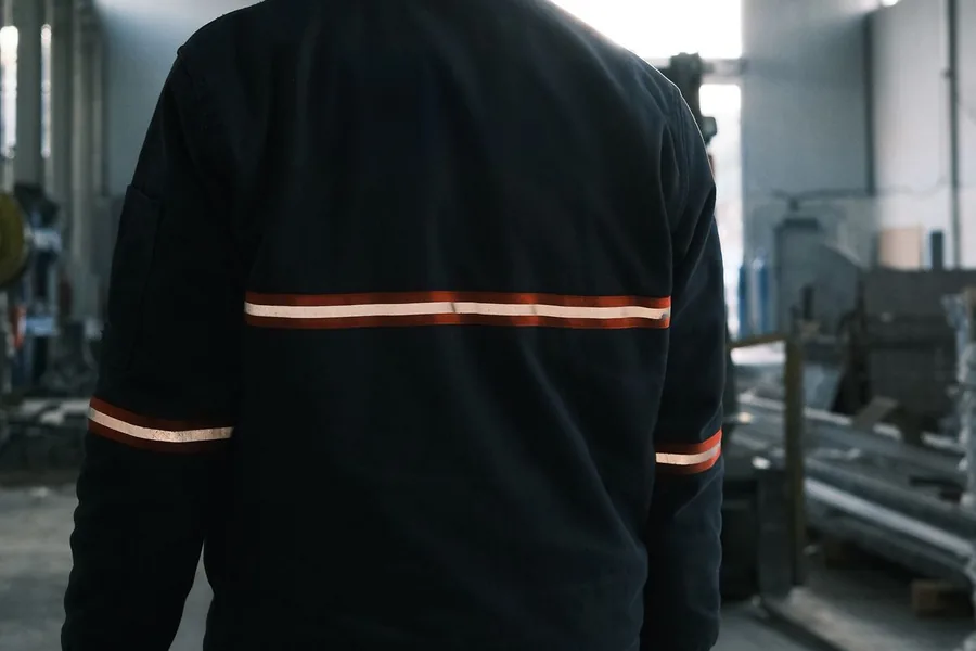 A worker in protective gear at an industrial facility